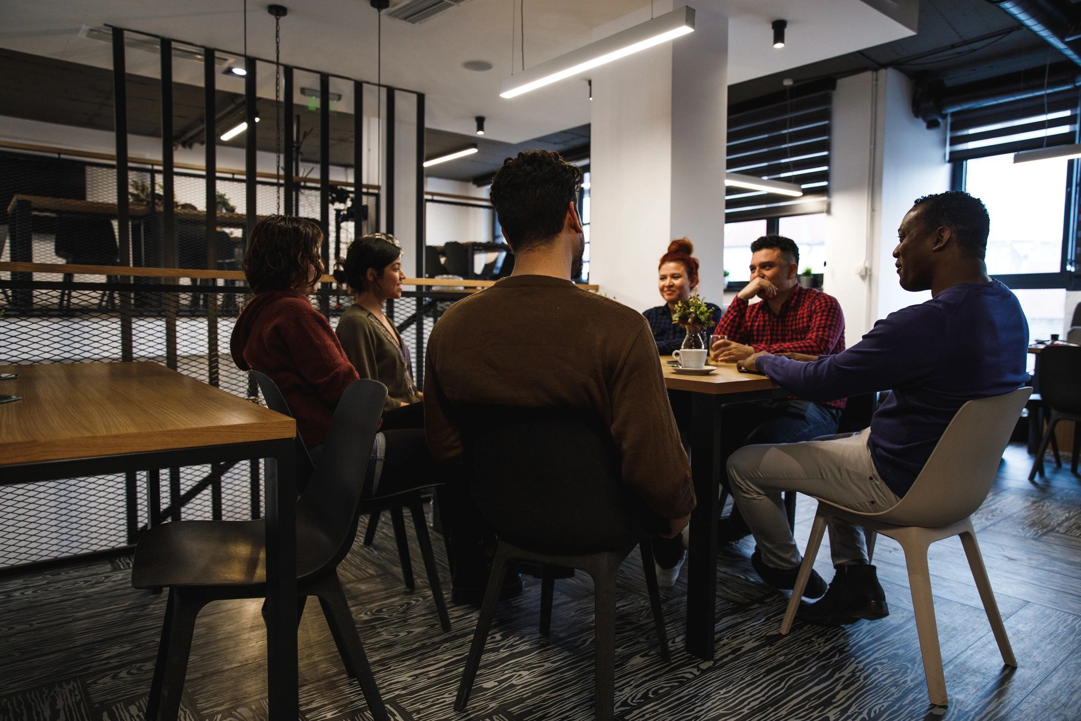 Group gathered around a table in a collaborative community setting