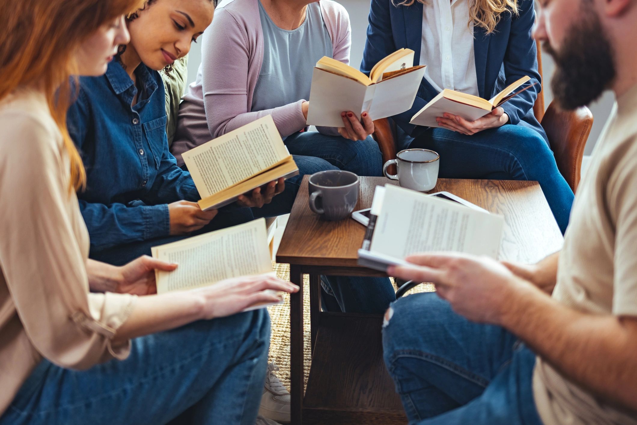 Community members reading and discussing books together