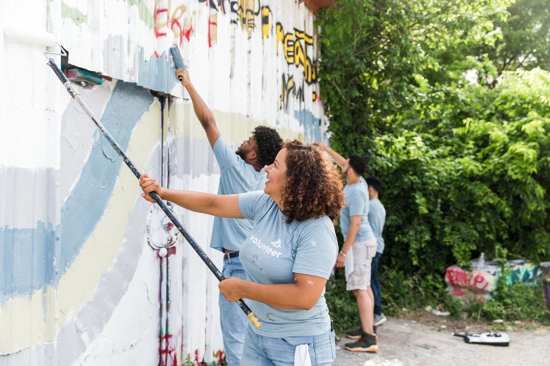 Volunteers painting a community mural together