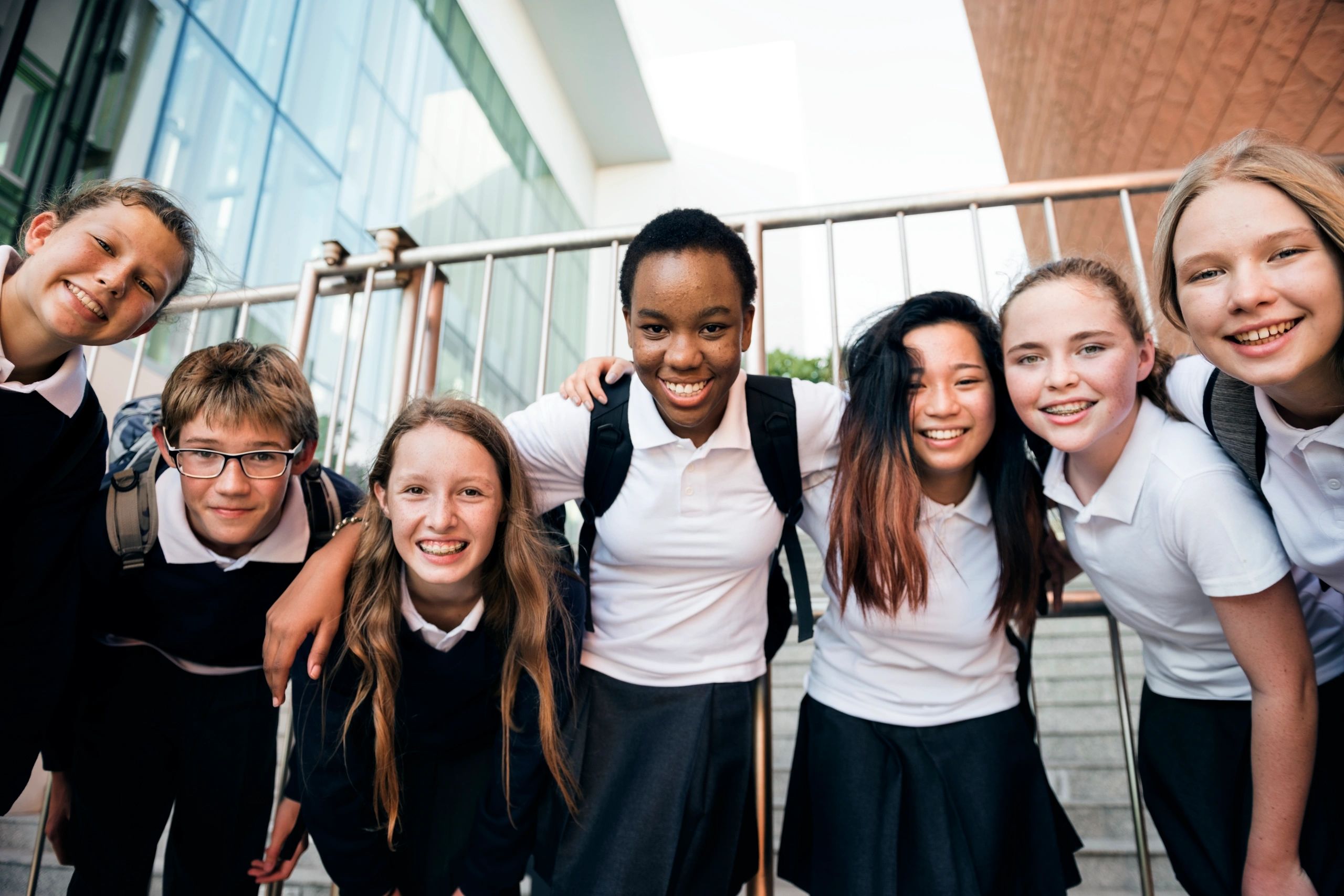 Group of students smiling together, representing school community and collaboration
