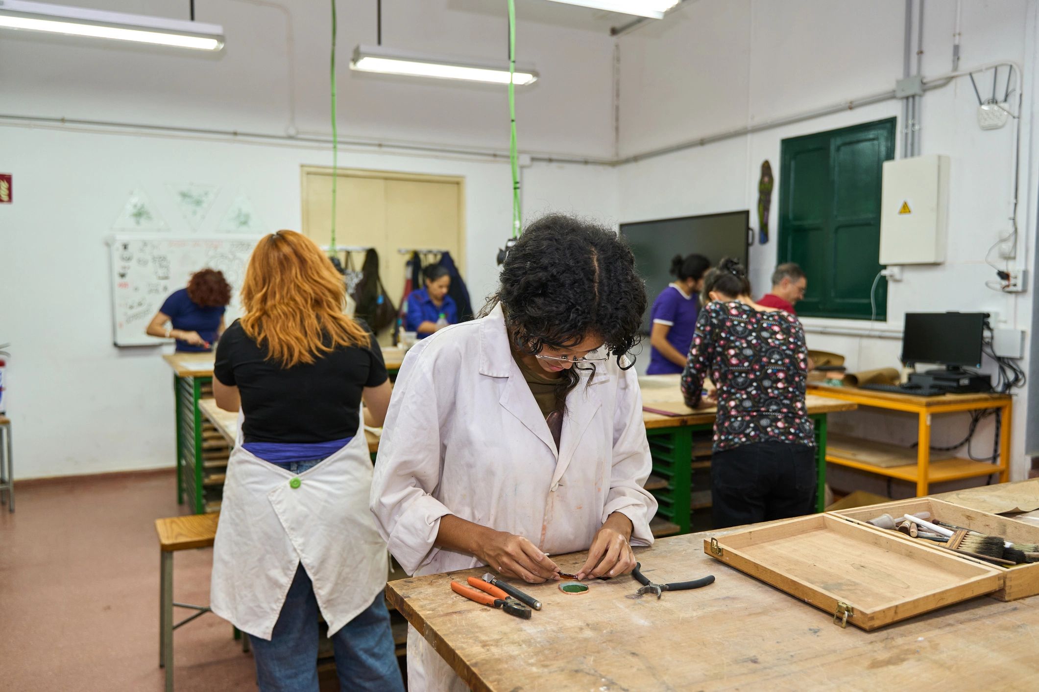 Participants learning hands-on creative skills in a workshop