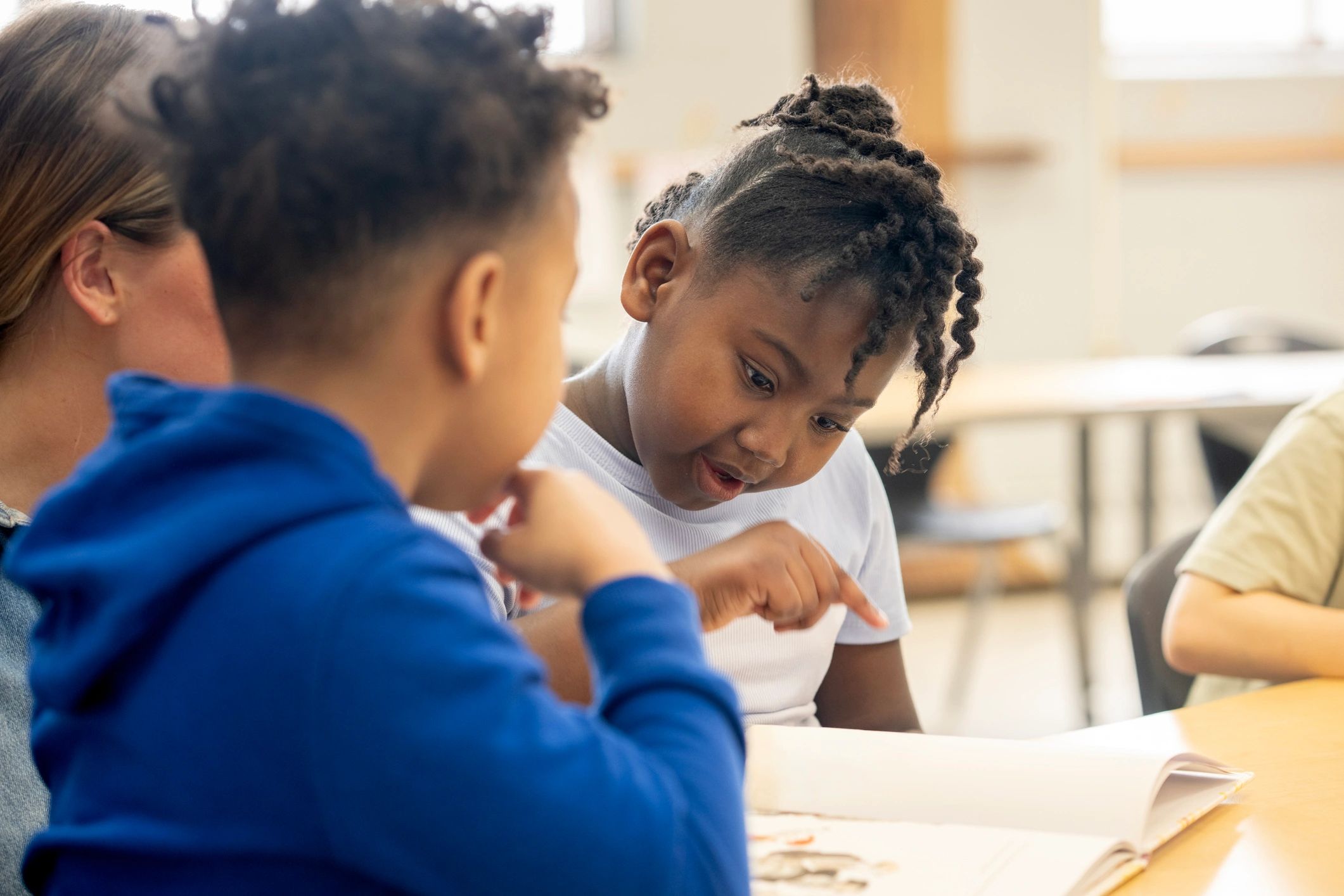 Students reading together in a bright classroom