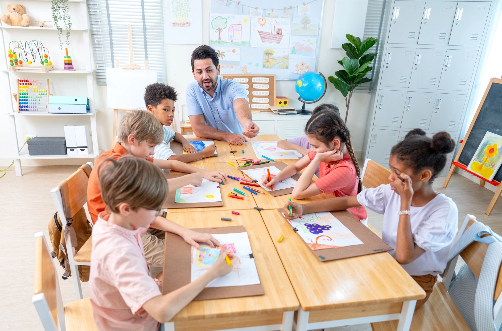 Teacher leading a drawing and painting classroom with children