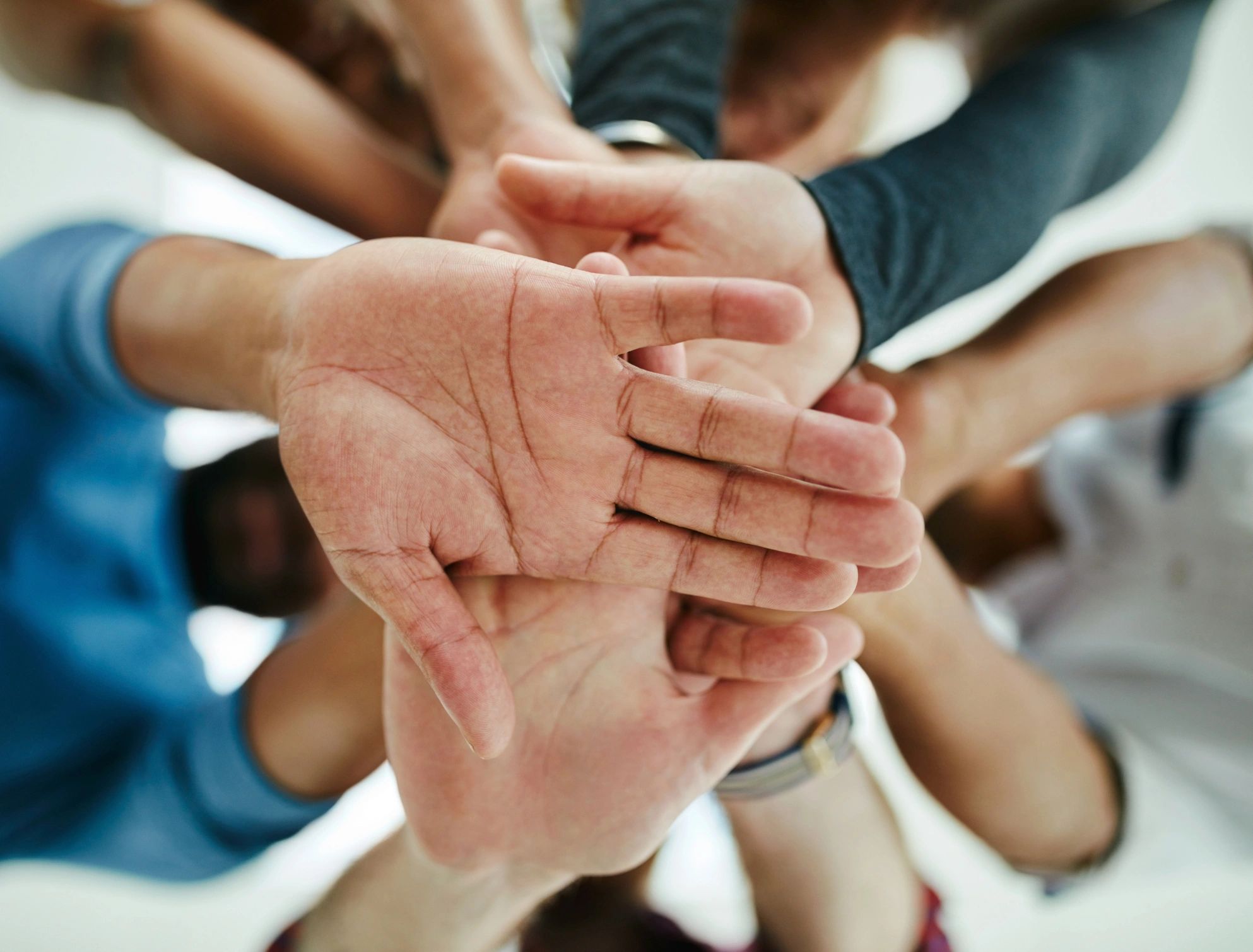Team hands joined in partnership