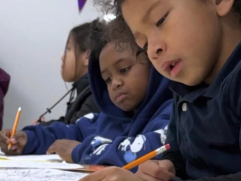 Young participants developing drawing and illustration skills in JCT International's Creative Entrepreneurship program in Milwaukee.